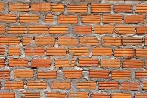 Brown block brick wall background, building wall photo