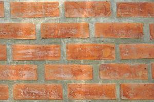 Brown block brick wall background, building wall photo
