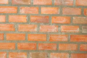 Brown block brick wall background, building wall photo