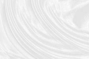 Smooth elegant white silk or satin luxury cloth texture can use as wedding background. Luxurious background design photo