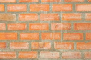 Brown block brick wall background, building wall photo