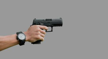 Isolated 9mm pistol gun holding in right hand of gun shooter with clipping paths. photo