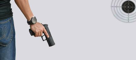 Isolated 9mm pistol gun holding in right hand of gun shooter with clipping paths. photo