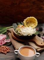 Selective focus of Asinan Betawi. The vegetable asinan of the Betawi people from Jakarta is preserved Chinese cabbage, cabbage, bean sprouts, tofu, and lettuce served with peanut sauce and krupuk photo