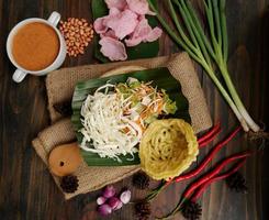 Selective focus of Asinan Betawi. The vegetable asinan of the Betawi people from Jakarta is preserved Chinese cabbage, cabbage, bean sprouts, tofu, and lettuce served with peanut sauce and krupuk photo