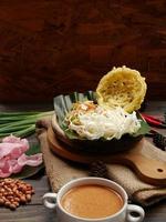 Selective focus of Asinan Betawi. The vegetable asinan of the Betawi people from Jakarta is preserved Chinese cabbage, cabbage, bean sprouts, tofu, and lettuce served with peanut sauce and krupuk photo