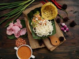 Selective focus of Asinan Betawi. The vegetable asinan of the Betawi people from Jakarta is preserved Chinese cabbage, cabbage, bean sprouts, tofu, and lettuce served with peanut sauce and krupuk photo