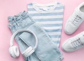 Child's t-shirt, shoes and headphones on blue backgrund photo