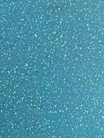 close up of aqua plastic board with crumbs pattern photo