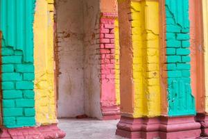 Red, Orange, yellow and blue color combination old Textured damage wall with Colorful Bricks. photo