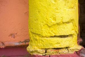 Red, Orange, yellow and blue color combination old Textured damage wall with Colorful Bricks. photo