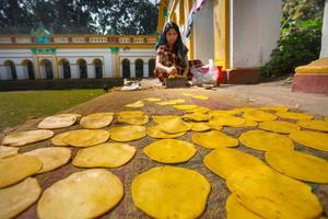 Bangladesh March 02, 2019, An small business women making on handmade Pappor Deep-fried Bread at Dinajpur Palace, Dinajpur, Bangladesh. photo