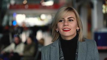 Portrait of a beautiful blonde girl with red lips. Slow motion video