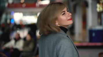 Portrait of a beautiful blonde girl with red lips. Slow motion video