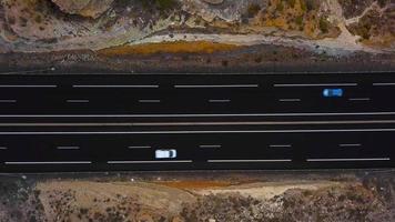Aerial view of a truck and other traffic driving along a highway on Tenerife, Canary Islands, Spain. Accelerated video