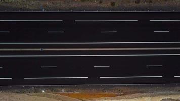 Aerial view of a truck and other traffic driving along a highway on Tenerife, Canary Islands, Spain. Accelerated video