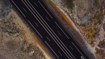 Aerial view of a truck and other traffic driving along a highway on Tenerife, Canary Islands, Spain. Accelerated video