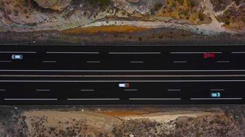 Aerial view of a truck and other traffic driving along a highway on Tenerife, Canary Islands, Spain. Accelerated video