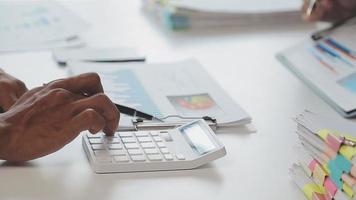 Financial analysts analyze business financial reports on a digital tablet planning investment project during a discussion at a meeting of corporate showing the results of their successful teamwork. video