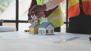 Construction and structure concept of Engineer or architect meeting for project working with partner and engineering tools on model building and blueprint in working site, contract for both companies. video