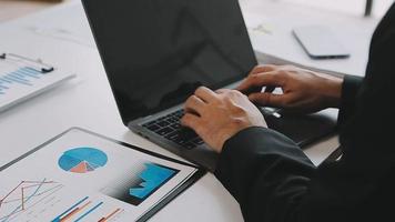 Financial analysts analyze business financial reports on a digital tablet planning investment project during a discussion at a meeting of corporate showing the results of their successful teamwork. video