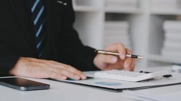 Financial analysts analyze business financial reports on a digital tablet planning investment project during a discussion at a meeting of corporate showing the results of their successful teamwork. video