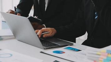 Financial analysts analyze business financial reports on a digital tablet planning investment project during a discussion at a meeting of corporate showing the results of their successful teamwork. video