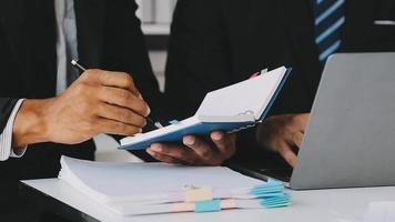 Financial analysts analyze business financial reports on a digital tablet planning investment project during a discussion at a meeting of corporate showing the results of their successful teamwork. video