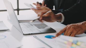 Financial analysts analyze business financial reports on a digital tablet planning investment project during a discussion at a meeting of corporate showing the results of their successful teamwork. video