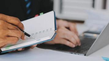 Financial analysts analyze business financial reports on a digital tablet planning investment project during a discussion at a meeting of corporate showing the results of their successful teamwork. video