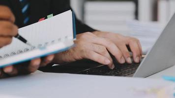 Financial analysts analyze business financial reports on a digital tablet planning investment project during a discussion at a meeting of corporate showing the results of their successful teamwork. video
