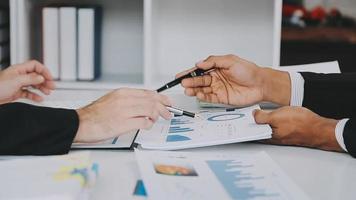 Financial analysts analyze business financial reports on a digital tablet planning investment project during a discussion at a meeting of corporate showing the results of their successful teamwork. video