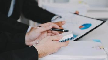 Financial analysts analyze business financial reports on a digital tablet planning investment project during a discussion at a meeting of corporate showing the results of their successful teamwork. video
