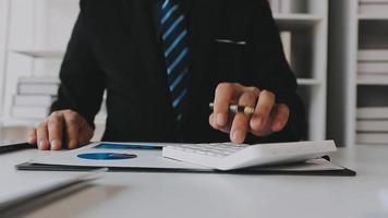 Financial analysts analyze business financial reports on a digital tablet planning investment project during a discussion at a meeting of corporate showing the results of their successful teamwork. video