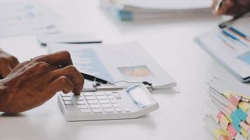 Financial analysts analyze business financial reports on a digital tablet planning investment project during a discussion at a meeting of corporate showing the results of their successful teamwork. video