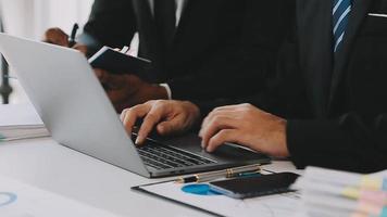 Financial analysts analyze business financial reports on a digital tablet planning investment project during a discussion at a meeting of corporate showing the results of their successful teamwork. video