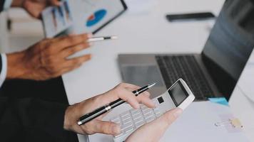 Financial analysts analyze business financial reports on a digital tablet planning investment project during a discussion at a meeting of corporate showing the results of their successful teamwork. video