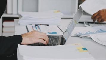 Financial analysts analyze business financial reports on a digital tablet planning investment project during a discussion at a meeting of corporate showing the results of their successful teamwork. video