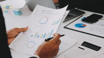 Financial analysts analyze business financial reports on a digital tablet planning investment project during a discussion at a meeting of corporate showing the results of their successful teamwork. video