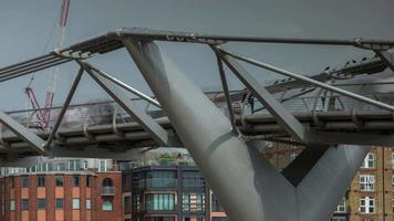 timelapse of the London skyline and people crossing the millennium bridge over the river thames video