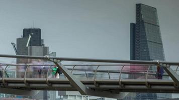 timelapse of the London skyline and people crossing the millennium bridge over the river thames video