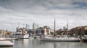 timelapse of the financial skyscrapers of london docklands, canary wharf in the distance, shot from the limehouse wharf and harbour video