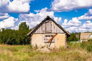 Beautiful old abandoned building farm house in countryside on natural background photo