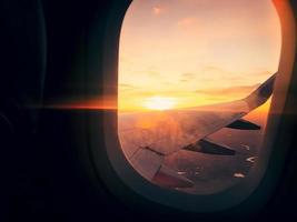 In plane flight view from window with stunning sunset background and copy paste vertical background photo