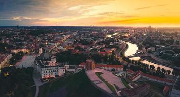 Aerial dramatic view Gediminas old castle tower in Old Town and Vilnius city panorama background, capital city of Lithuania. Scenic landmarks and sightseeing in eastern europe photo