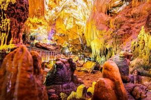 Beautiful Prometheus cave with no tourists and illuminated geological million years formations photo