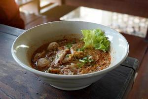 Tom Yum Noodles with Lime Pork, Great Taste, Sour, Sweet, Spicy, Lime Fragrance In a ceramic cup ready to serve. Soft and selective focus. photo