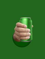 Man holding aluminum can with water droplets on green background photo