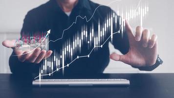 investment financial strategy concept, man  working on keyboard virtual trading graph photo