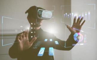 data analysis concept. man wearing VR glasses working with virtual data charts photo